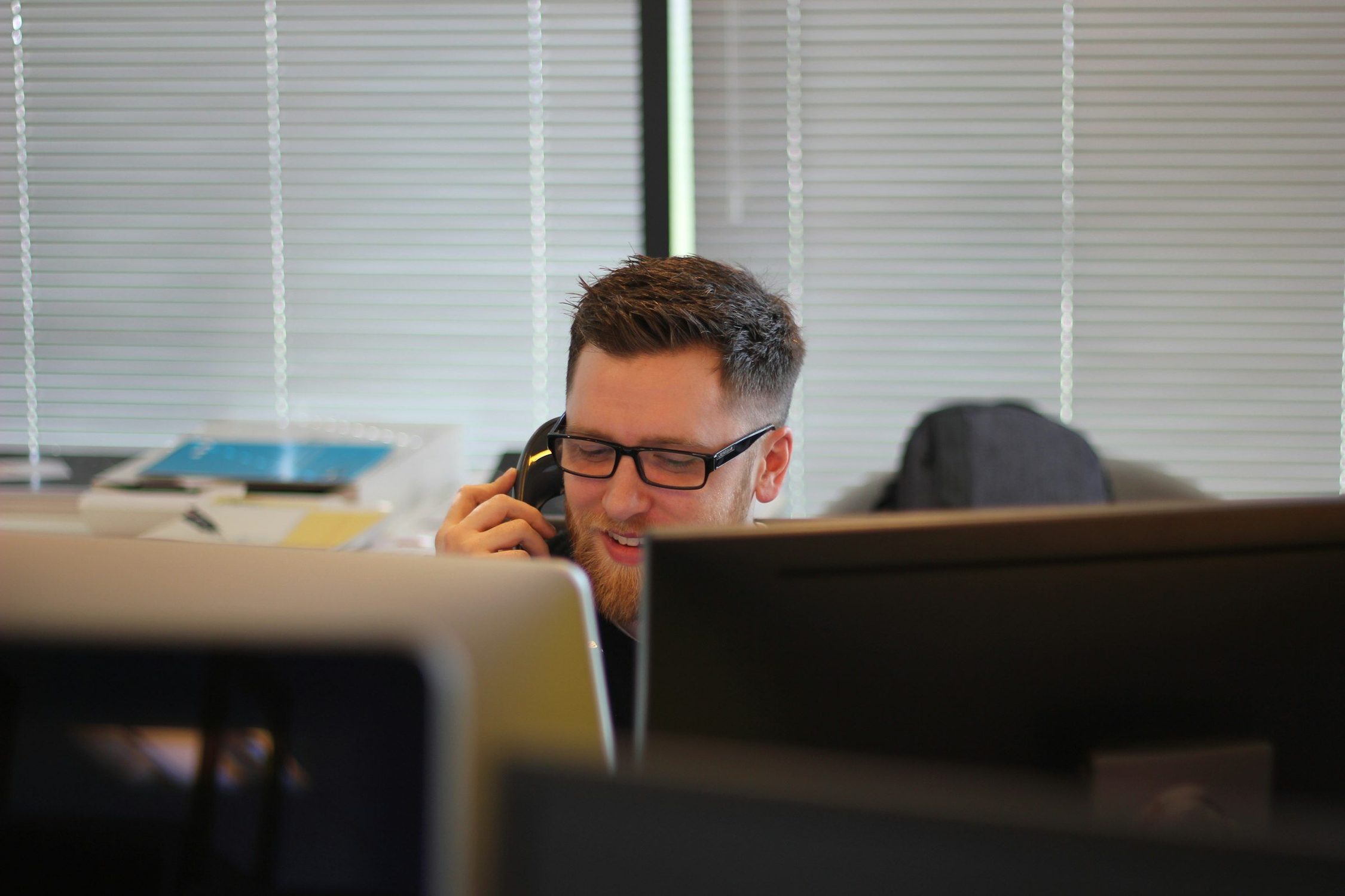 Support technician taking a call at a desk